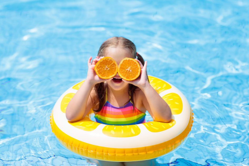 Child In Swimming Pool. Kid Eating Orange. Puntogar
